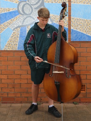 Student Mark Tomlinson posed for photo with double bass cello